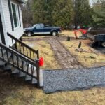 Freshly installed gravel walkway leading from a home entrance to the driveway in New Brunswick.